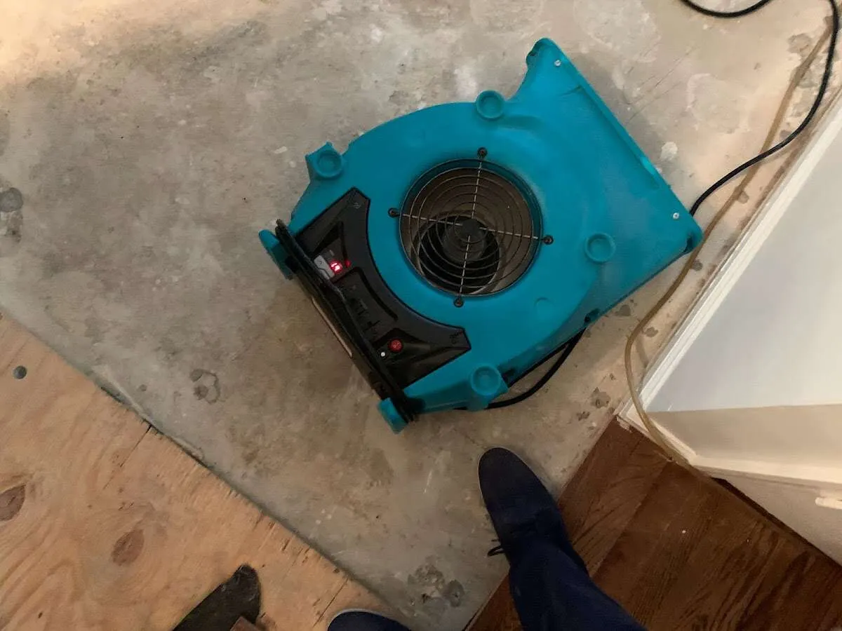 Air mover drying subfloor during Leak Detection & Repair in Hudson